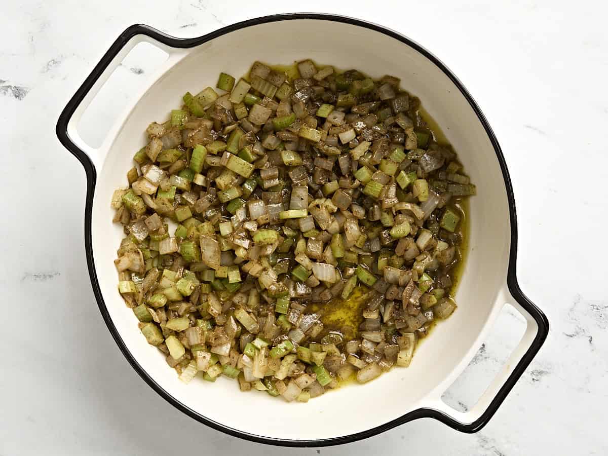 Cooked aromatics and celery in a skillet. 