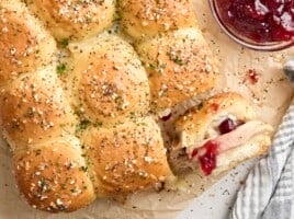 Overhead view of turkey sliders, with one roll turned on its side.