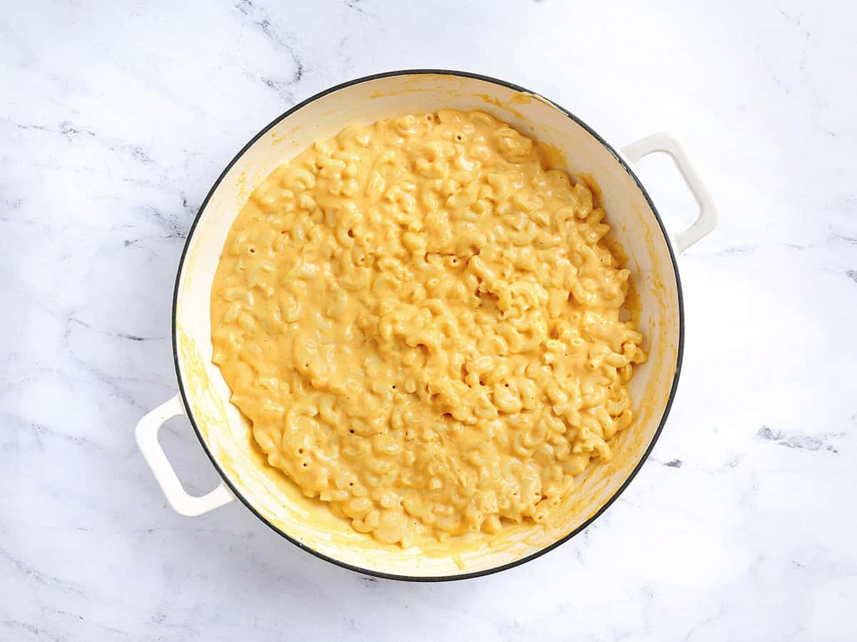 Finished macaroni and cheese in a skillet.