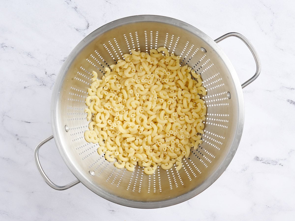 Cooked macaroni in a colander.