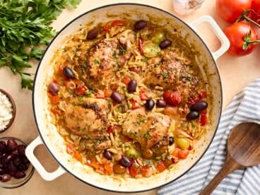 Overhead view of Greek chicken and orzo in a skillet.