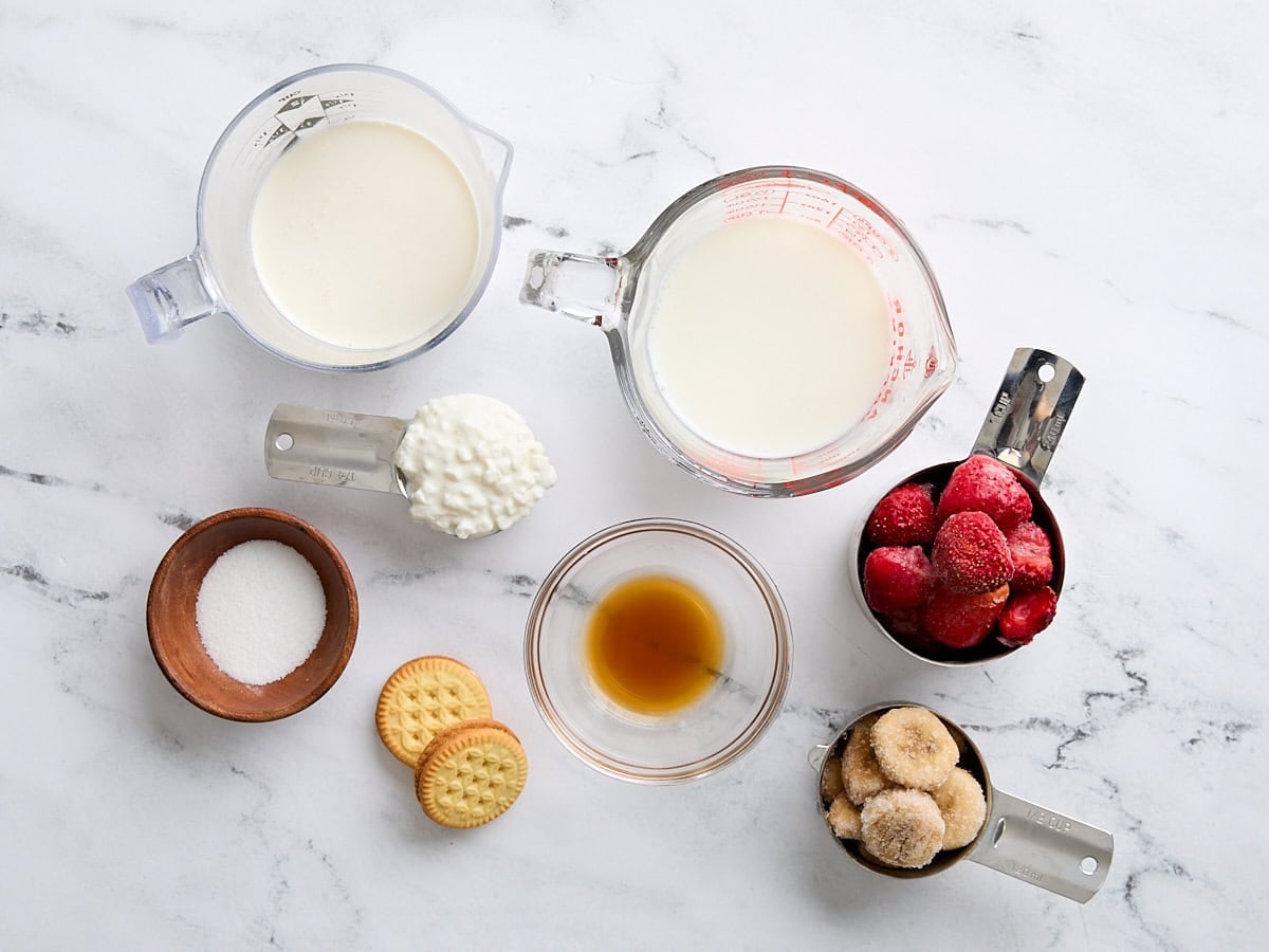 The ingredients to make a strawberry cheesecake smoothie.