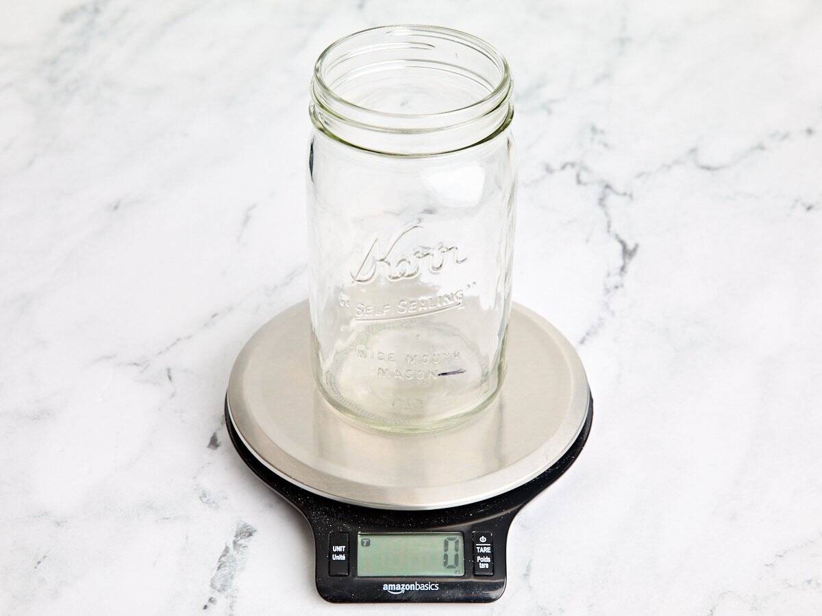 An empty mason jar on kitchen scales.