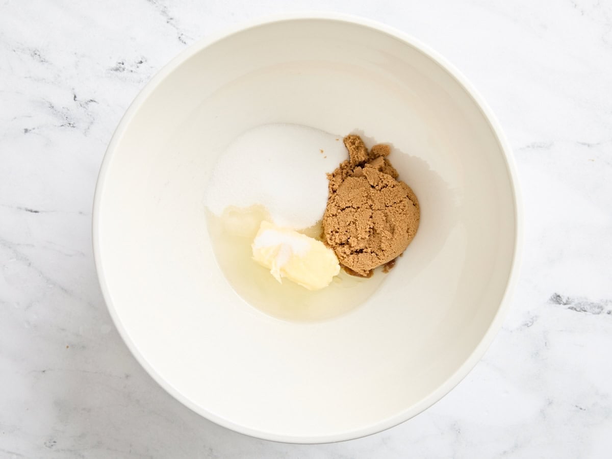 Oil, butter, sugar, and brown sugar in a bowl.