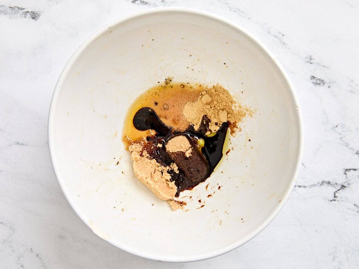 Salt, ginger powder, brown sugar, soy sauce, and toasted sesame seed oil in a mixing bowl.