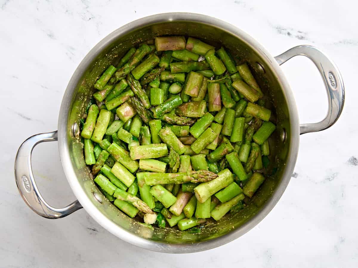 Sauteed asparagus in a sauce pot.