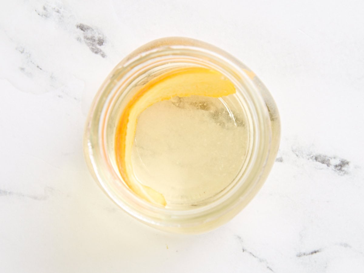 Homemade simple syrup added to a mason jar for storing.