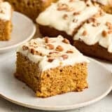 Side view of a slice of carrot cake on a plate