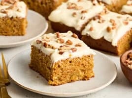Side view of a slice of carrot cake on a plate
