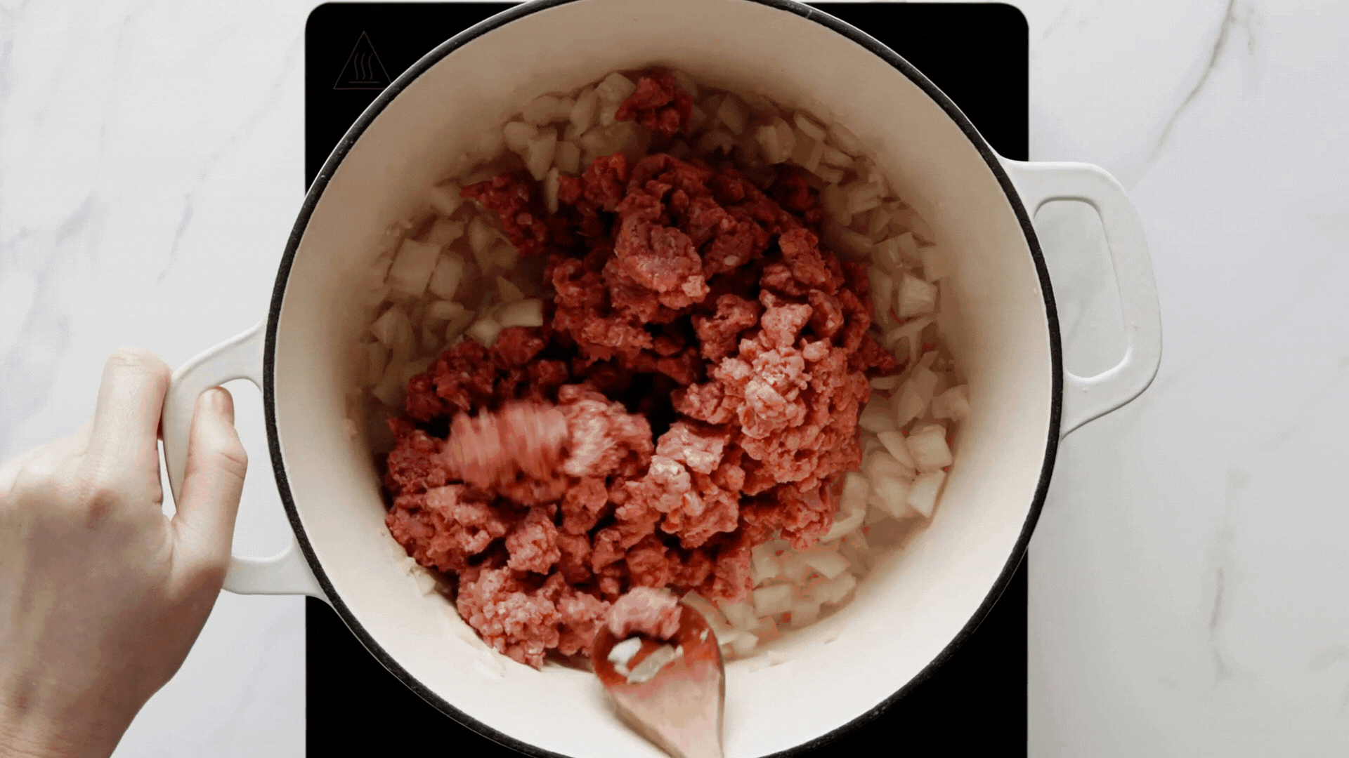 canned beans and tomatoes being added to mizture