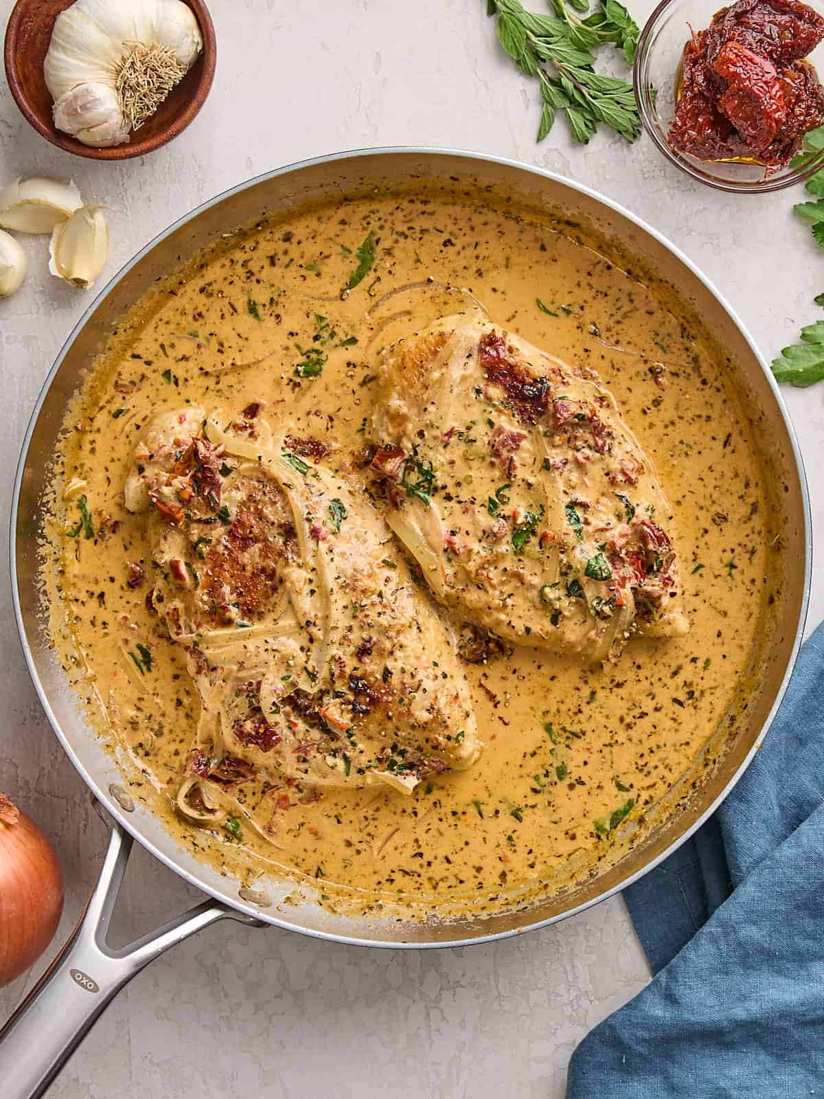 Overhead view of marry me chicken in a skillet.