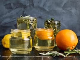 Side view of different mason jars filled with simple syrup.