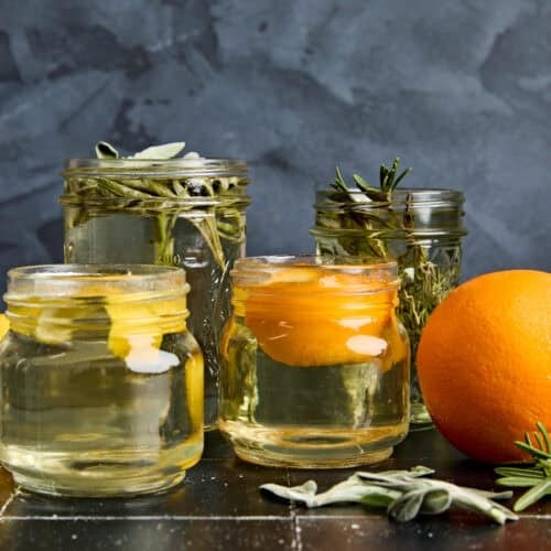 Side view of different mason jars filled with simple syrup.