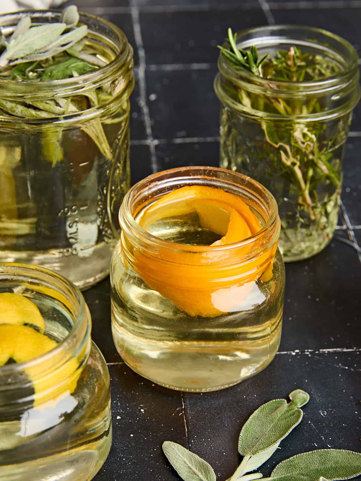 Overhead view of different flavored simple syrups in jars.