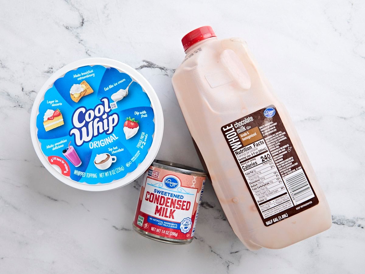 A bottle of chocolate milk, a can of sweetened condensed milk, and a tub of cool whip.