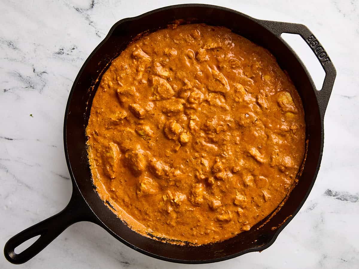 Finished butter chicken recipe in a cast iron skillet.