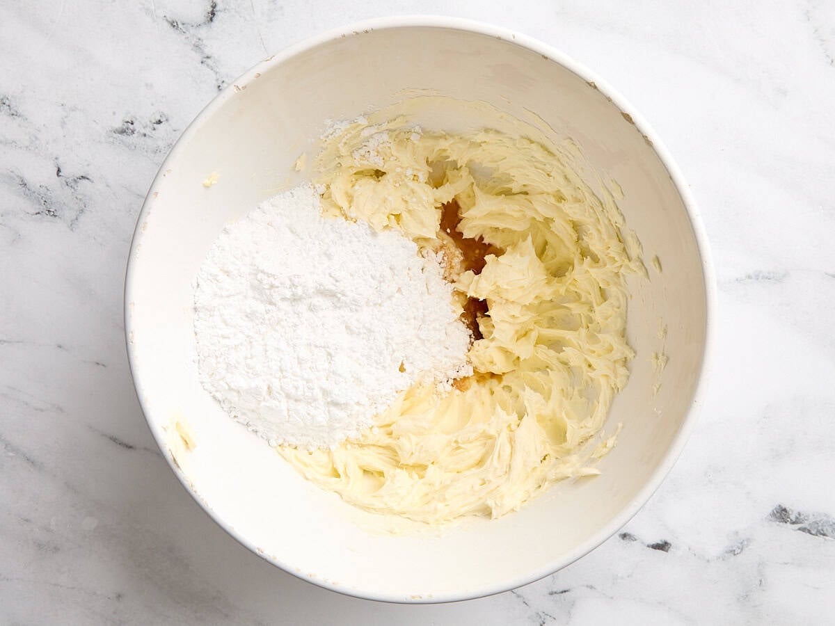 Creamed butter and powdered sugar added to a mixing bowl.