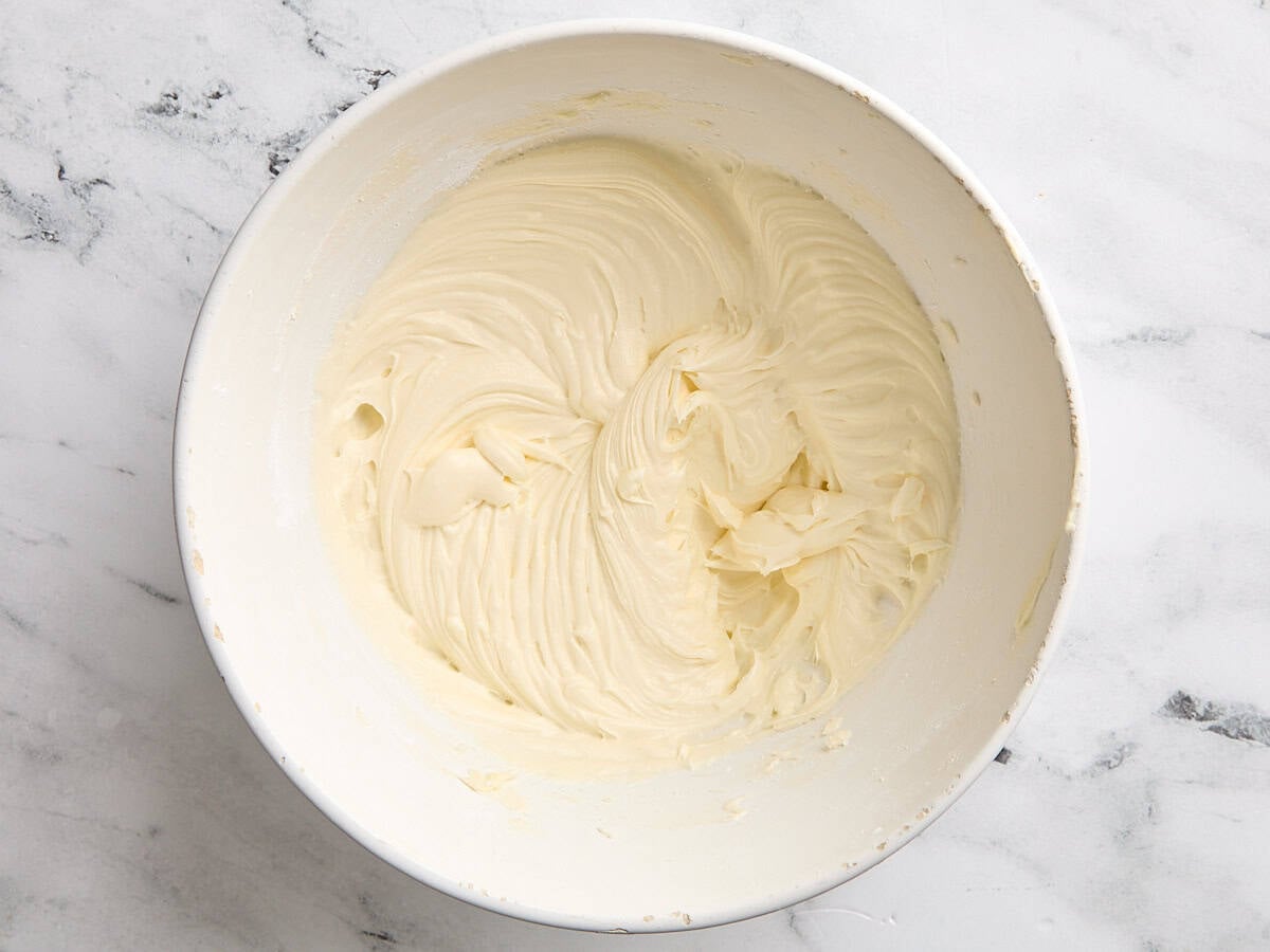 A freshly whipped coconut frosting in a mixing bowl.