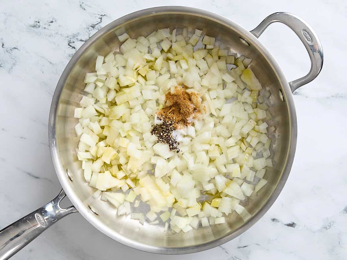 Onion and spices in a skillet.