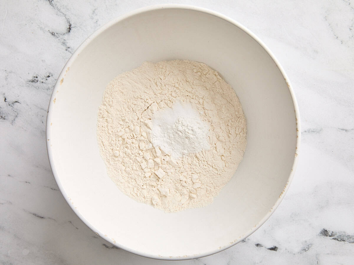 Flour, baking powder, and salt in a bowl.