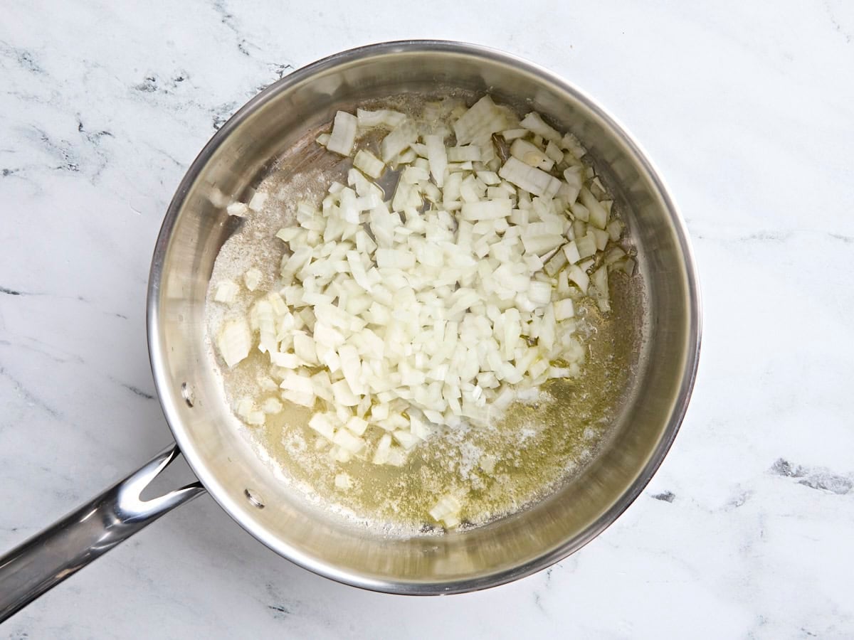 Olive oil, butter, and diced onion in a skillet.