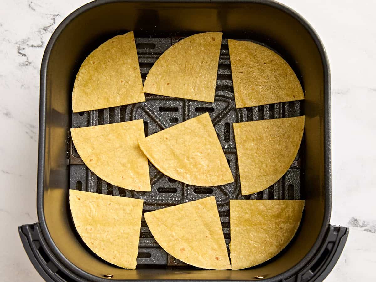 Corn tortilla quarters in an air fryer.