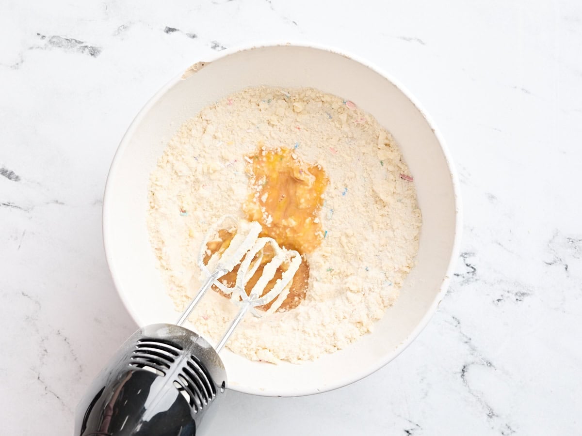 Egg and vanilla mixture added to the butter flour mix for sugar cookie bars.