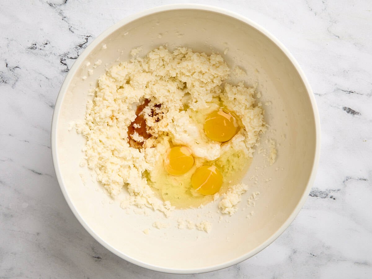 Creamed butter and eggs in a bowl.