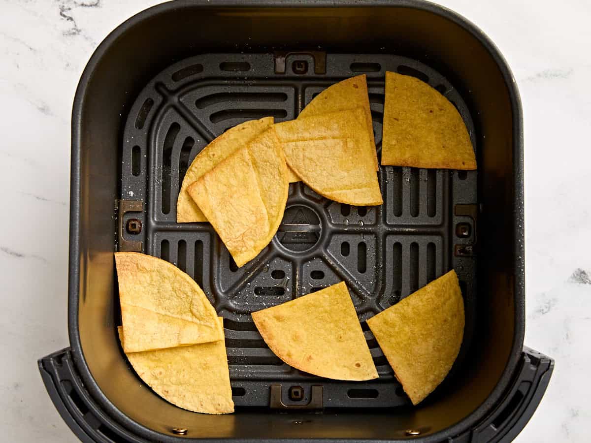 Air fryer tortilla chips in an air fryer.