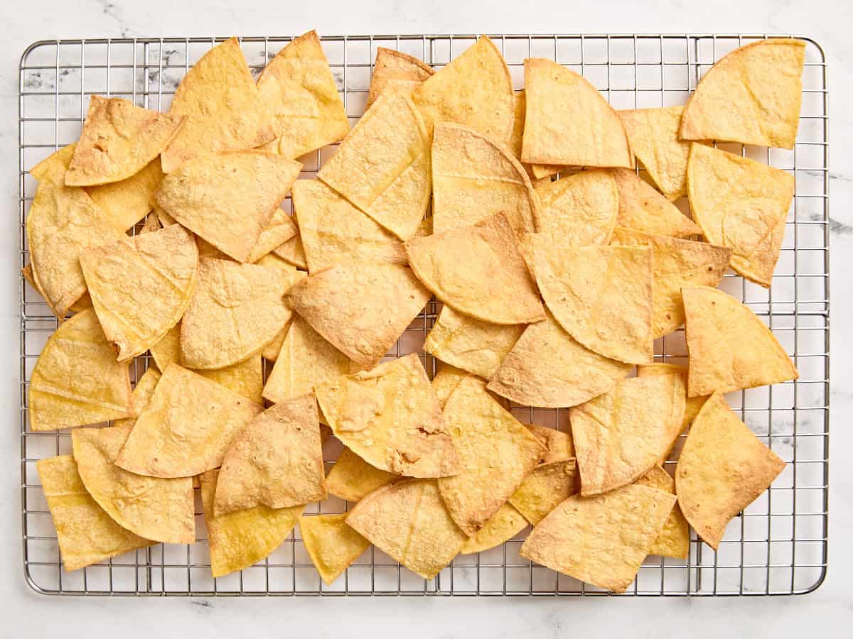 Homemade air fried tortilla chips on a cooling rack.