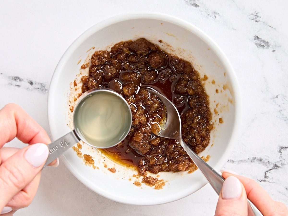 Pineapple juice being poured into a glaze for Easter ham steaks,