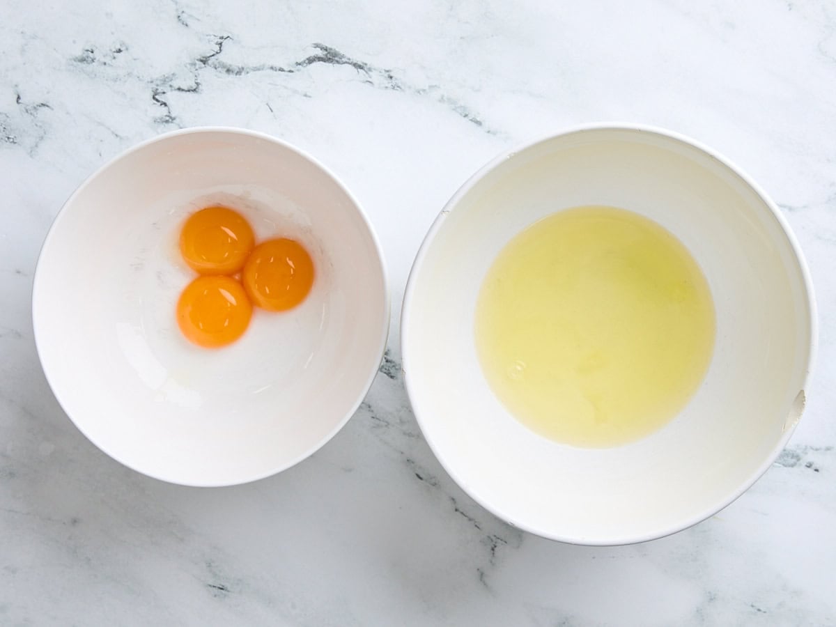 3 egg yolks and the separated egg whites in different bowls.