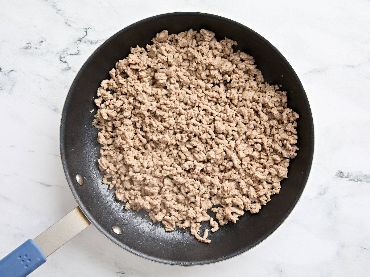 Ground turkey cooking in a skillet.