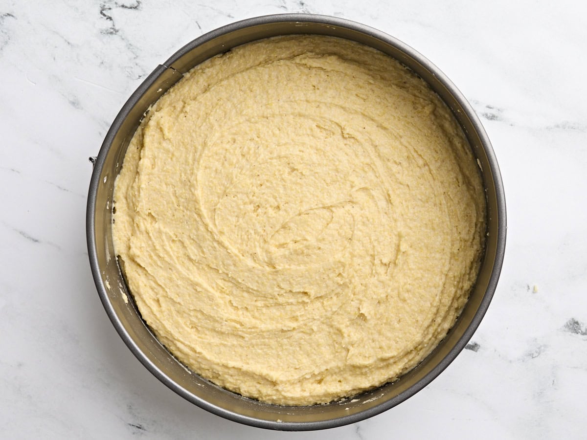 Cornbread cake batter in a cake pan.