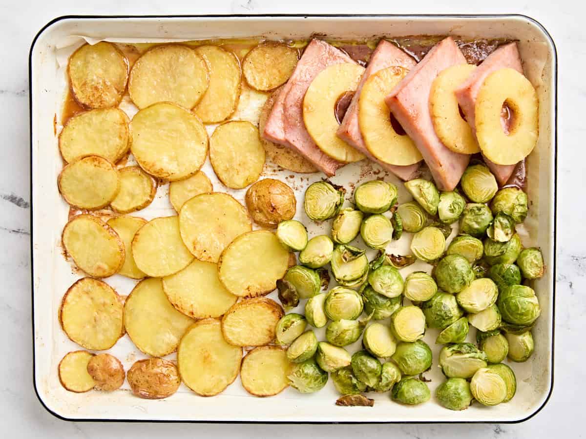 A finished sheet pan Easter dinner after baking.