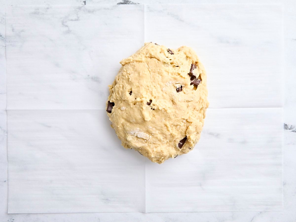 Sourdough scone dough on a piece of parchment paper.