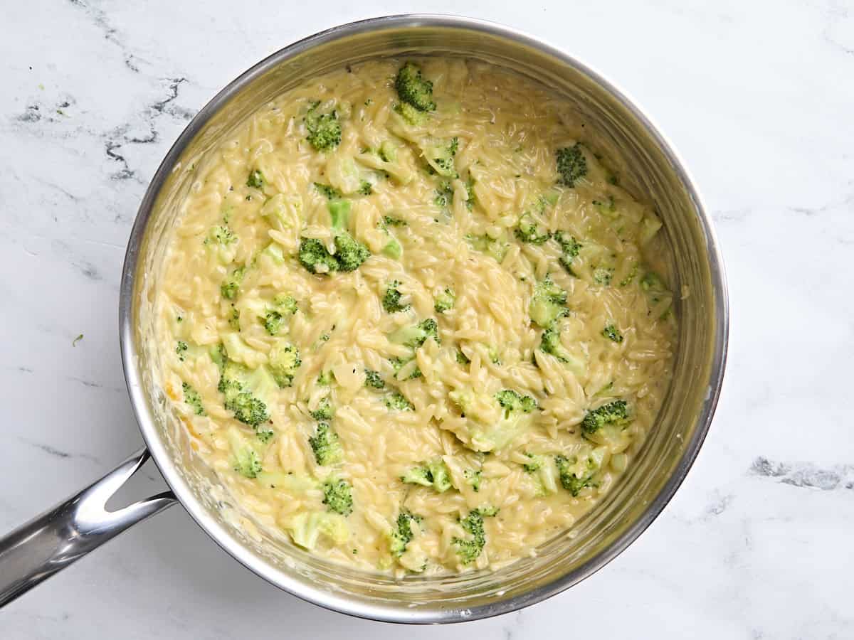 Finished broccoli cheddar orzo dinner in a skillet.