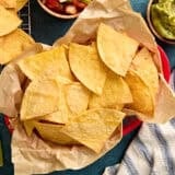 Overhead view of air fryer tortilla chips in a basket.