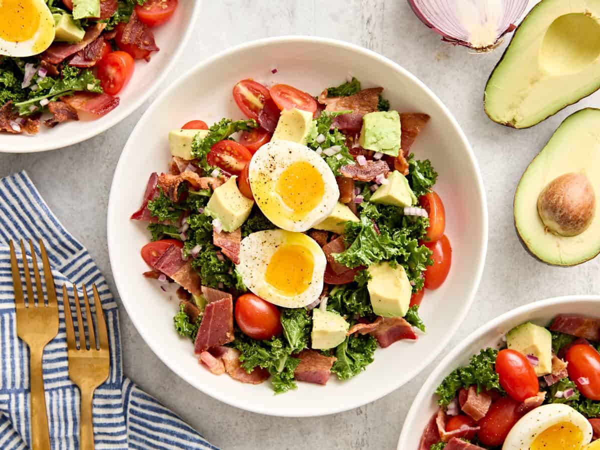 Overhead view of a blt avocado brunch salad bowl.