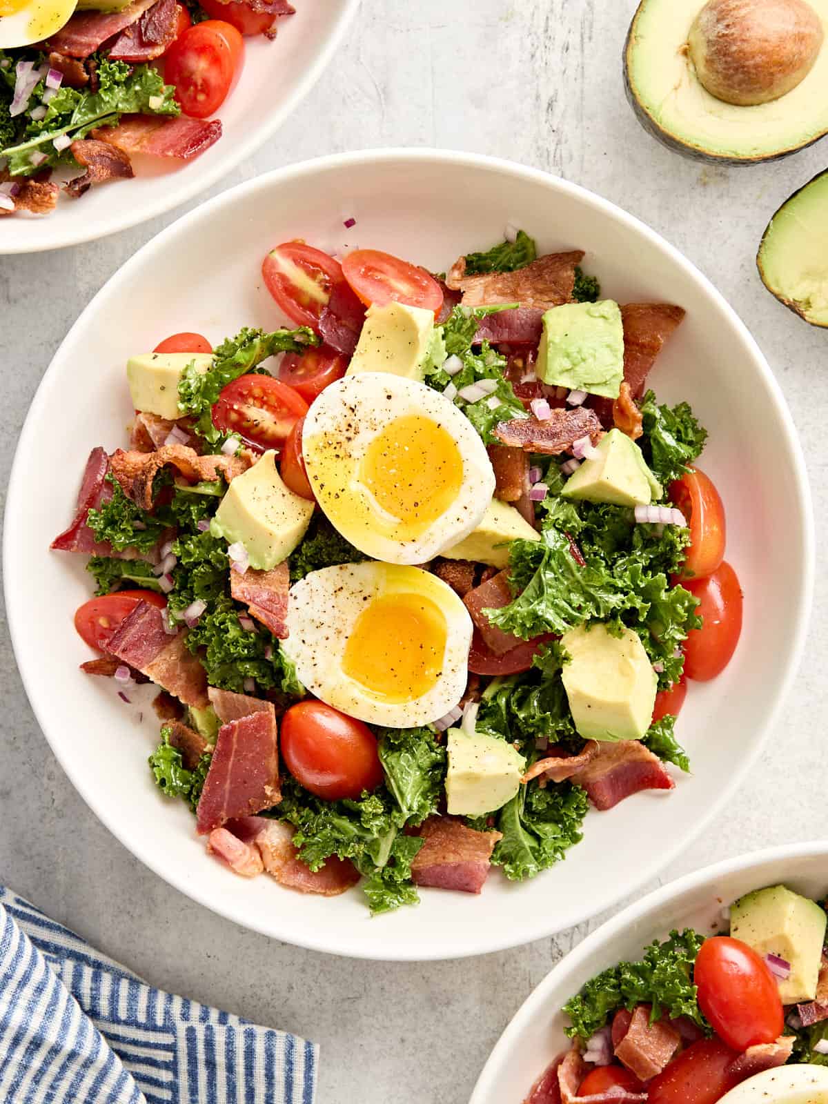 Overhead view of a blt avocado brunch salad bowl.
