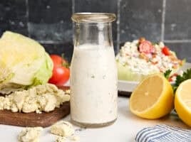 Side view of a bottle of homemade blue cheese dressing.