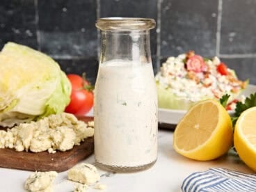Side view of a bottle of homemade blue cheese dressing.
