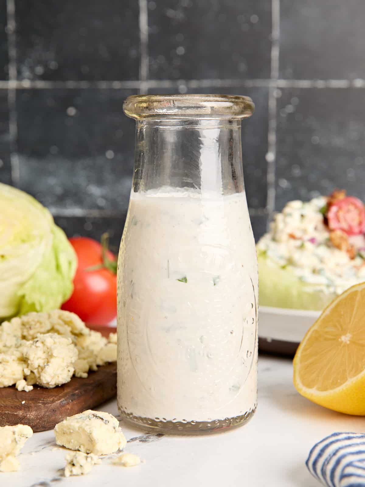 Side view of a bottle of homemade blue cheese dressing.