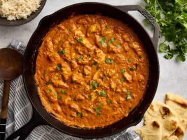 Overhead view of a homemade butter chicken in a cast iron skillet.