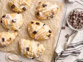 Overhead view of homemade chocolate chip sourdough scones on a parchment lined wire rack.