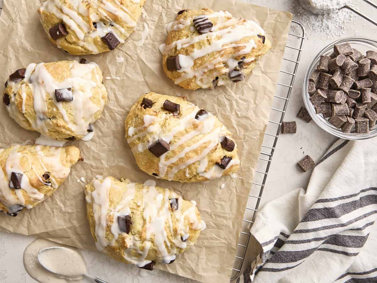 Overhead view of homemade chocolate chip sourdough scones on a parchment lined wire rack.