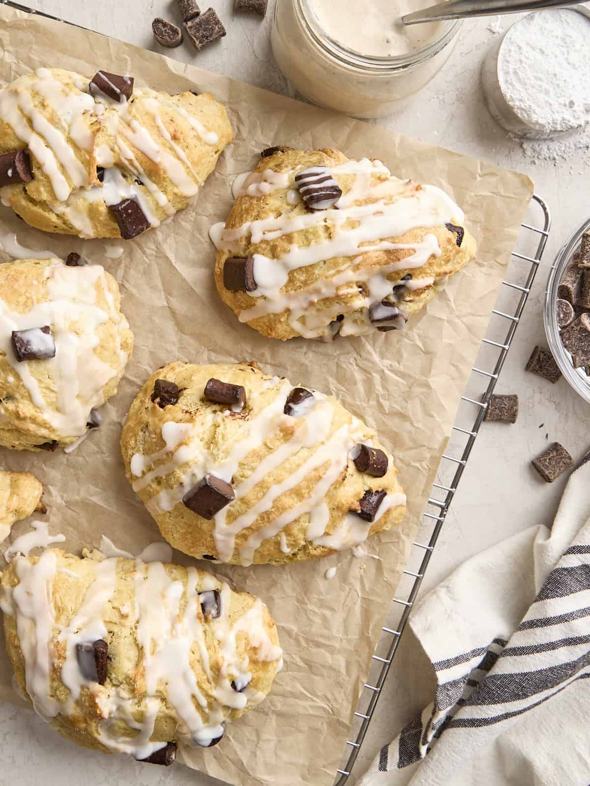 Overhead view of homemade chocolate chip sourdough scones on a parchment lined wire rack.