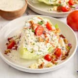 Side view of a wedge salad on a plate.