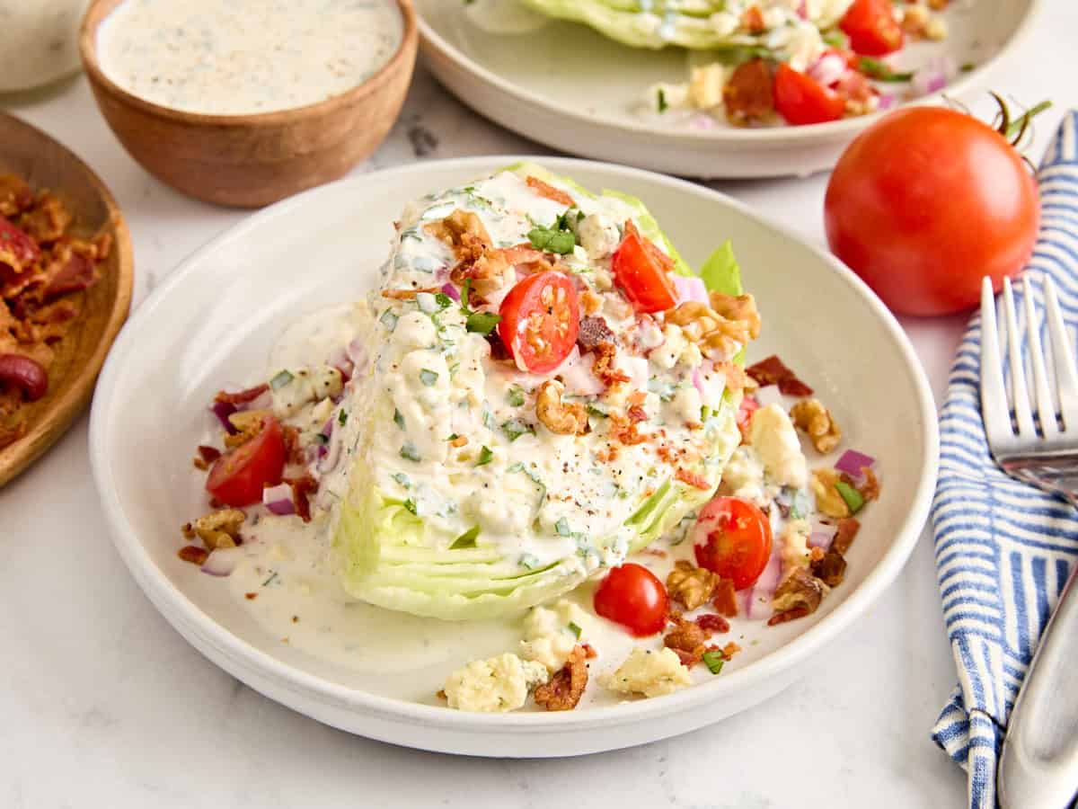 Side view of a wedge salad on a plate.