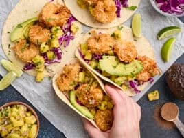 Overhead view of coconut shrimp tacos with pineapple salsa.
